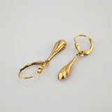 Elegante goldene hängende Ohrringe mit Scharnierverschluss und länglichem Tropfendesign.